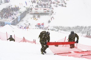 Volunteers take down nets of the men's downhill course of the FIS Alpine Ski World Cup at the Lauberhorn, in Wengen, Switzerland, on Saturday, Jan. 14, 2017. The race had to be cancelled due to heavy snowfall.